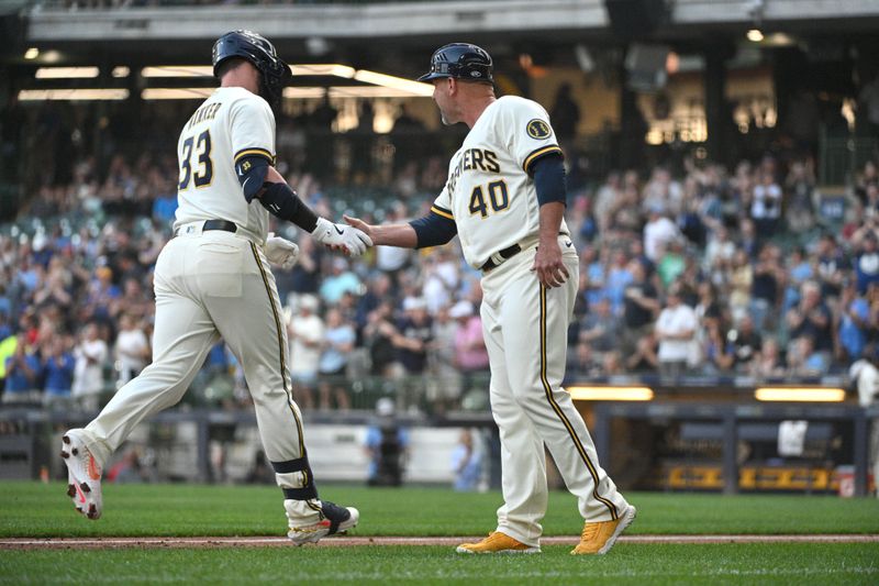 Jun 20, 2023; Milwaukee, Wisconsin, USA; Milwaukee Brewers designated hitter Jesse Winker (33) is congratulated by Milwaukee Brewers third base coach Jason Lane (40) after hitting a home run against the Arizona Diamondbacks in the fourth inning at American Family Field. Mandatory Credit: Michael McLoone-USA TODAY Sports