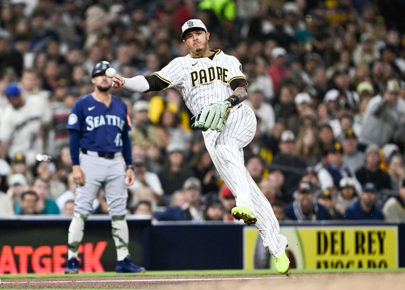 May 16, 2025; San Diego, California, USA; San Diego Padres third baseman Manny Machado (13) throws to first but does not get the out against Seattle Mariners left fielder Randy Arozarena (56) during sixth inning at Petco Park. Mandatory Credit: Denis Poroy-Imagn Images