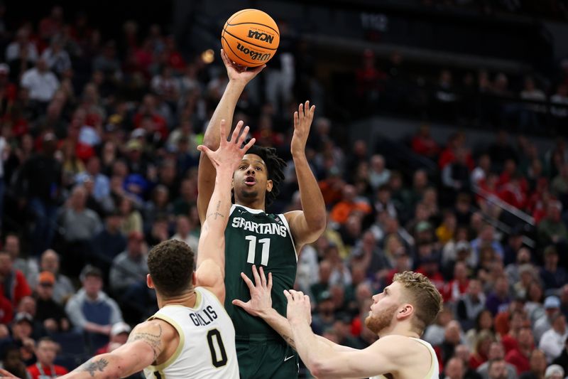 Mar 15, 2024; Minneapolis, MN, USA; Michigan State Spartans guard A.J. Hoggard (11) shoots as Purdue Boilermakers forward Mason Gillis (0) and forward Caleb Furst (1) defend during the second half at Target Center. Mandatory Credit: Matt Krohn-USA TODAY Sports