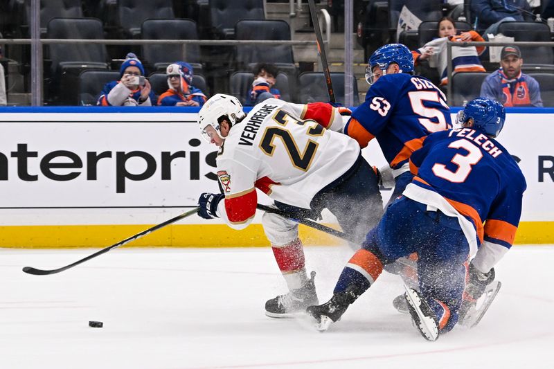 Oct 26, 2024; Elmont, New York, USA;  New York Islanders defenseman Adam Pelech (3) and New York Islanders center Casey Cizikas (53) defend against Florida Panthers center Carter Verhaeghe (23) during the third period at UBS Arena. Mandatory Credit: Dennis Schneidler-Imagn Images