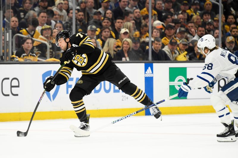 May 4, 2024; Boston, Massachusetts, USA; Boston Bruins defenseman Charlie McAvoy (73) fires the puck in the zone ahead of Toronto Maple Leafs right wing William Nylander (88) during the first period in game seven of the first round of the 2024 Stanley Cup Playoffs at TD Garden. Mandatory Credit: Bob DeChiara-USA TODAY Sports