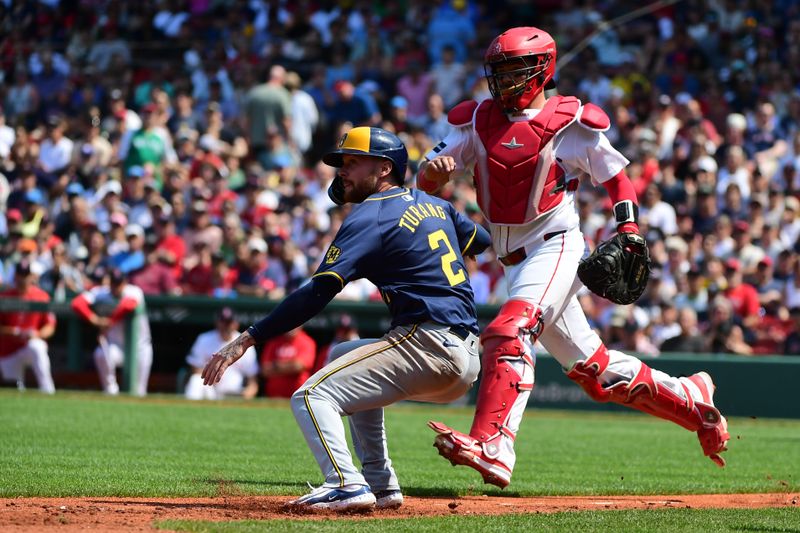 May 26, 2024; Boston, Massachusetts, USA;  Milwaukee Brewers second baseman Brice Turang (2) is caught in a rundown with Boston Red Sox catcher Reese McGuire (3) during the fifth inning at Fenway Park. Mandatory Credit: Bob DeChiara-USA TODAY Sports