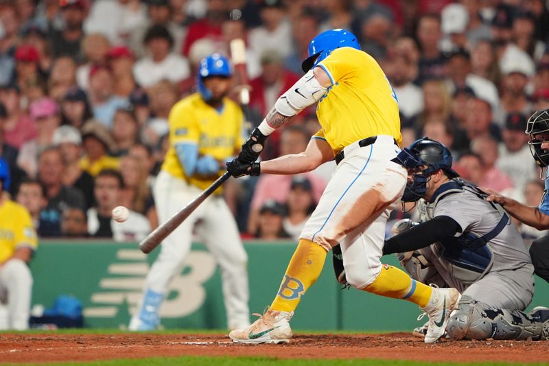 Jul 27, 2024; Boston, Massachusetts, USA; Boston Red Sox left fielder Tyler O'Neill (17) hits a home run against the New York Yankees during the seventh inning at Fenway Park. Mandatory Credit: Gregory Fisher-USA TODAY Sports