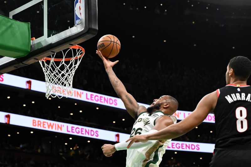 BOSTON, MASSACHUSETTS - APRIL 07: Xavier Tillman #26 of the Boston Celtics attempts a layup against Kris Murray #8 of the Portland Trail Blazers during the fourth quarter at the TD Garden on April 07, 2024 in Boston, Massachusetts. NOTE TO USER: User expressly acknowledges and agrees that, by downloading and or using this photograph, User is consenting to the terms and conditions of the Getty Images License Agreement. (Photo by Brian Fluharty/Getty Images)