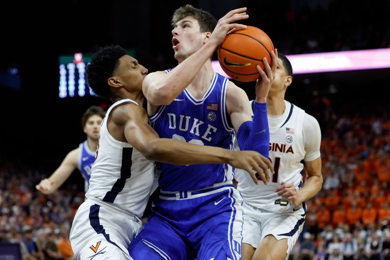 Feb 11, 2023; Charlottesville, Virginia, USA; Duke Blue Devils center Kyle Filipowski (30) drives to the basket as Virginia Cavaliers guard Ryan Dunn (13) defends in the first half at John Paul Jones Arena. Mandatory Credit: Geoff Burke-USA TODAY Sports