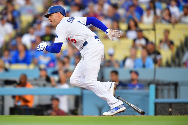 Jul 24, 2023; Los Angeles, California, USA; Los Angeles Dodgers first baseman Freddie Freeman (5) hits a single against the Toronto Blue Jays during the first inning at Dodger Stadium. Mandatory Credit: Gary A. Vasquez-USA TODAY Sports