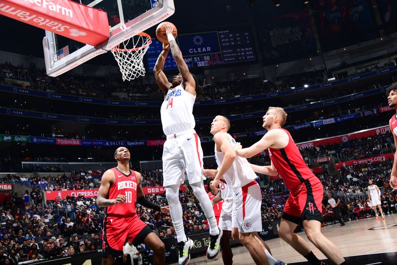 LOS ANGELES, CA - APIRL 14: Terance Mann #14 of the LA Clippers drives to the basket during the game against the Houston Rockets on April 14, 2024 at Crypto.Com Arena in Los Angeles, California. NOTE TO USER: User expressly acknowledges and agrees that, by downloading and/or using this Photograph, user is consenting to the terms and conditions of the Getty Images License Agreement. Mandatory Copyright Notice: Copyright 2024 NBAE (Photo by Adam Pantozzi/NBAE via Getty Images)