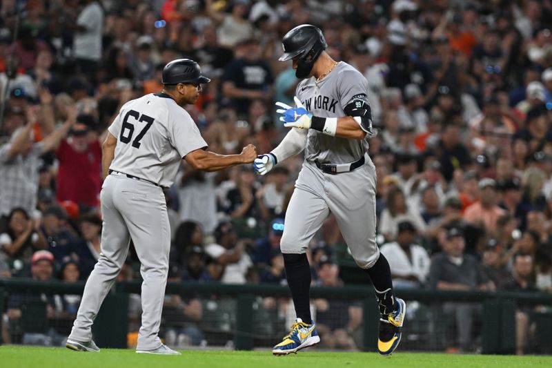 Aug 16, 2024; Detroit, Michigan, USA;  New York Yankees center fielder Aaron Judge (99) celebrates with third base coach Luis Rojas (67) after hitting a solo home run against the Detroit Tigers in the eighth inning at Comerica Park. Mandatory Credit: Lon Horwedel-USA TODAY Sports