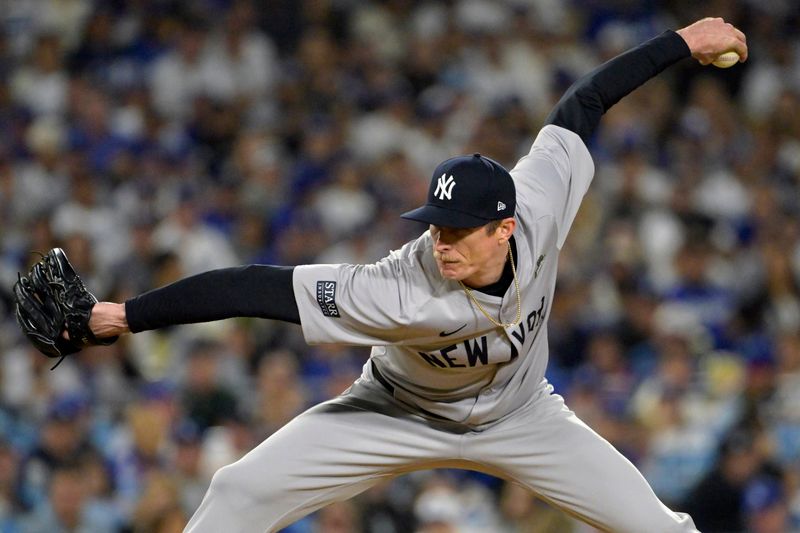 Oct 26, 2024; Los Angeles, California, USA; New York Yankees pitcher Tim Hill (54) pitches in the fifth inning against the Los Angeles Dodgers during game two of the 2024 MLB World Series at Dodger Stadium. Mandatory Credit: Jayne Kamin-Oncea-Imagn Images