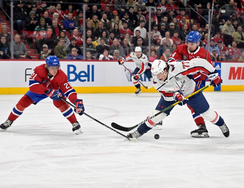 Feb 17, 2024; Montreal, Quebec, CAN; Washington Capitals forward T.J. Oshie (77) plays the puck and Montreal Canadiens defenseman Kaiden Guhle (21) defends with the help of teammate forward Nick Suzuki (14) during the first period at the Bell Centre. Mandatory Credit: Eric Bolte-USA TODAY Sports