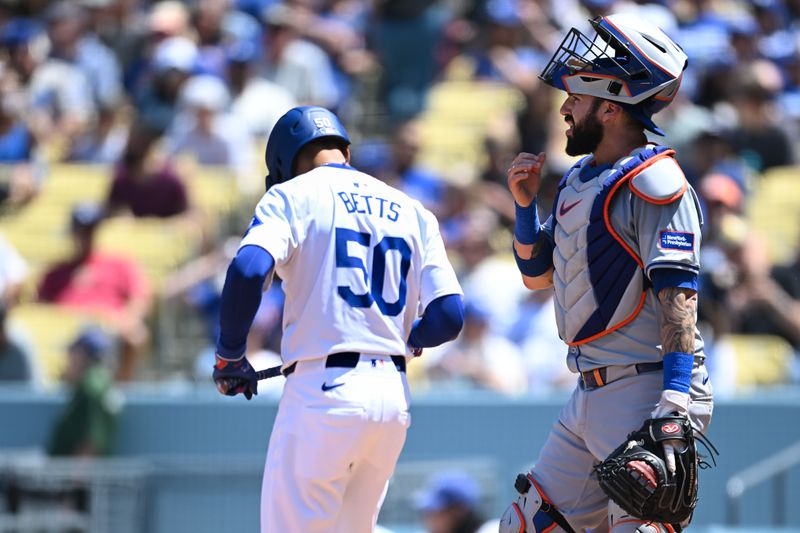 Apr 21, 2024; Los Angeles, California, USA; New York Mets catcher Tomás Nido (3) at home plate against Los Angeles Dodgers shortstop Mookie Betts (50) during the third inning at Dodger Stadium. Mandatory Credit: Jonathan Hui-USA TODAY Sports