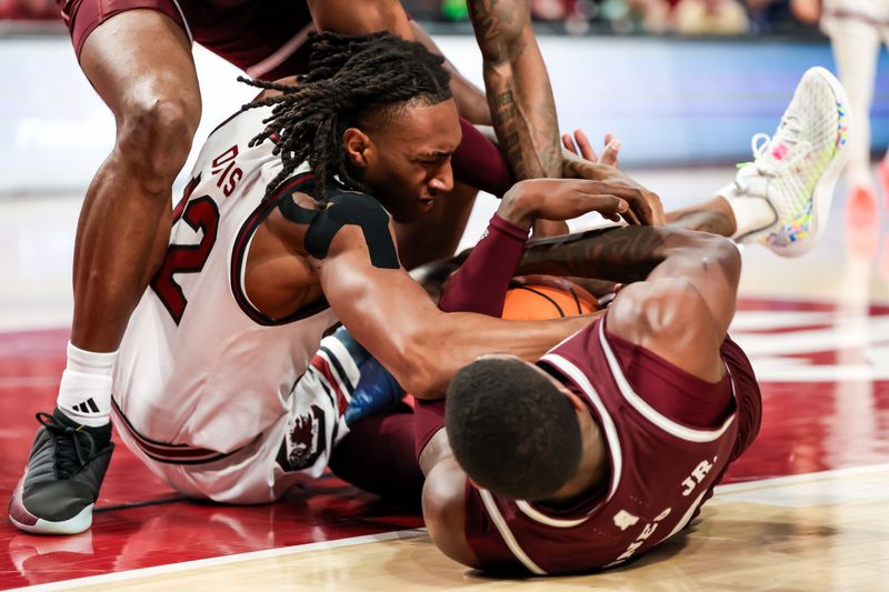 Jan 6, 2024; Columbia, South Carolina, USA; South Carolina Gamecocks guard Zachary Davis (12) and Mississippi State Bulldogs guard Shawn Jones Jr. (5) battle for the ball in the first half at Colonial Life Arena. Mandatory Credit: Jeff Blake-USA TODAY Sports