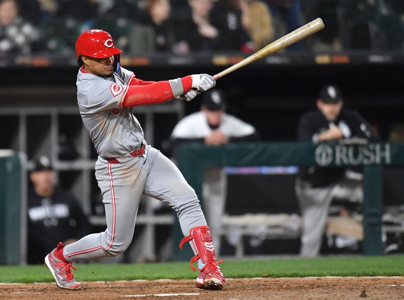 Apr 12, 2024; Chicago, Illinois, USA; Cincinnati Reds third base Santiago Espinal (4) hits a two-run single during the ninth inning against the Chicago White Sox at Guaranteed Rate Field. Mandatory Credit: Patrick Gorski-USA TODAY Sports