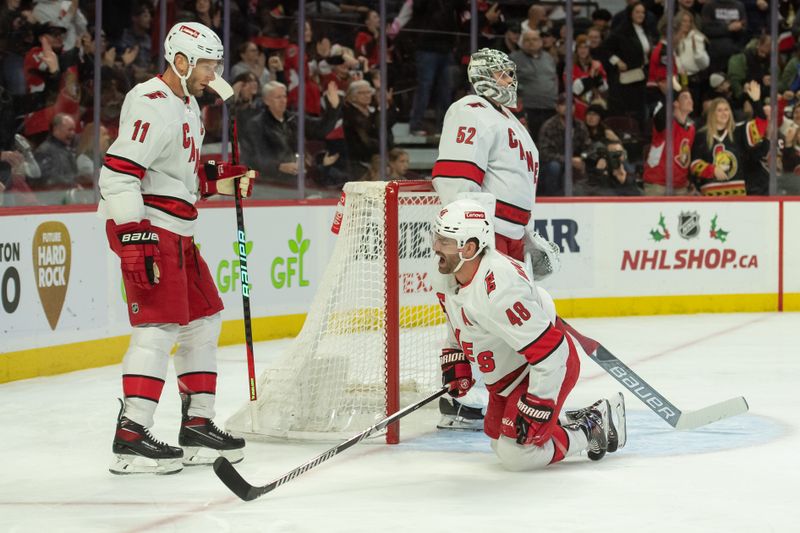 Dec 12, 2023; Ottawa, Ontario, CAN; Carolina Hurricanes left wing Jordan Martinook (48) reacts to a goal scored following his slide into the post during the first period against the Ottawa Senators at the Canadian Tire Centre. Mandatory Credit: Marc DesRosiers-USA TODAY Sports