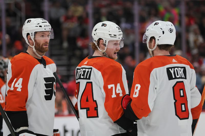 Feb 6, 2024; Sunrise, Florida, USA; Philadelphia Flyers right wing Owen Tippett (74) talks to defenseman Cam York (8) against the Florida Panthers during the second period at Amerant Bank Arena. Mandatory Credit: Sam Navarro-USA TODAY Sports