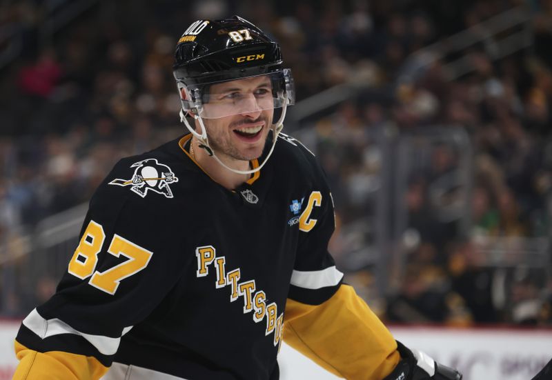 Mar 11, 2025; Pittsburgh, Pennsylvania, USA;  Pittsburgh Penguins center Sidney Crosby (87) smiles on the ice against the Vegas Golden Knights during the third period at PPG Paints Arena. Mandatory Credit: Charles LeClaire-Imagn Images