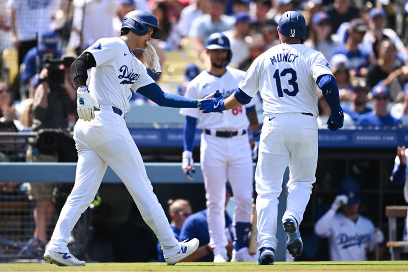 Apr 20, 2024; Los Angeles, California, USA; Los Angeles Dodgers designated hitter Shohei Ohtani (17) fives third baseman Max Muncy (13) after scoring against the New York Mets during the fifth inning at Dodger Stadium. Mandatory Credit: Jonathan Hui-USA TODAY Sports