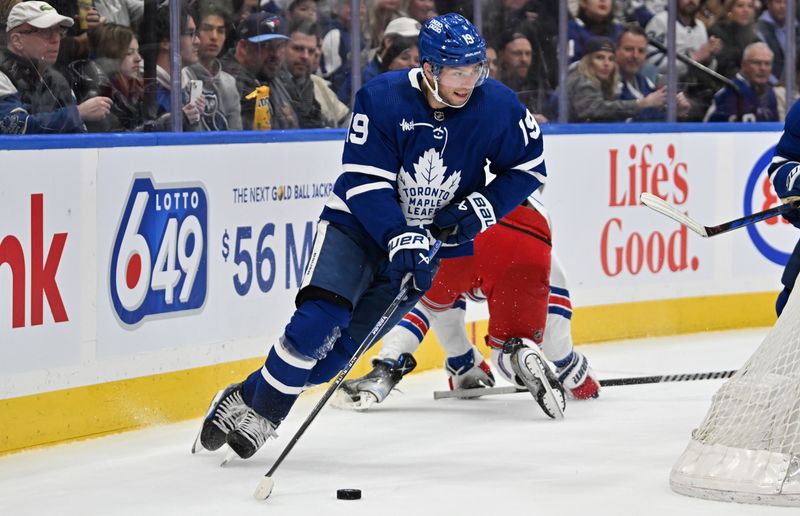 Mar 2, 2024; Toronto, Ontario, CAN;  Toronto Maple Leafs forward Calle Jarnkrok (19) skates with the puck against the New York Rangers in overtime at Scotiabank Arena. Mandatory Credit: Dan Hamilton-USA TODAY Sports