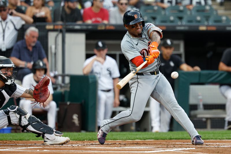 Aug 24, 2024; Chicago, Illinois, USA; Detroit Tigers second baseman Andy Ibanez (77) hits an RBI-single against the Chicago White Sox during the first inning at Guaranteed Rate Field. Mandatory Credit: Kamil Krzaczynski-USA TODAY Sports