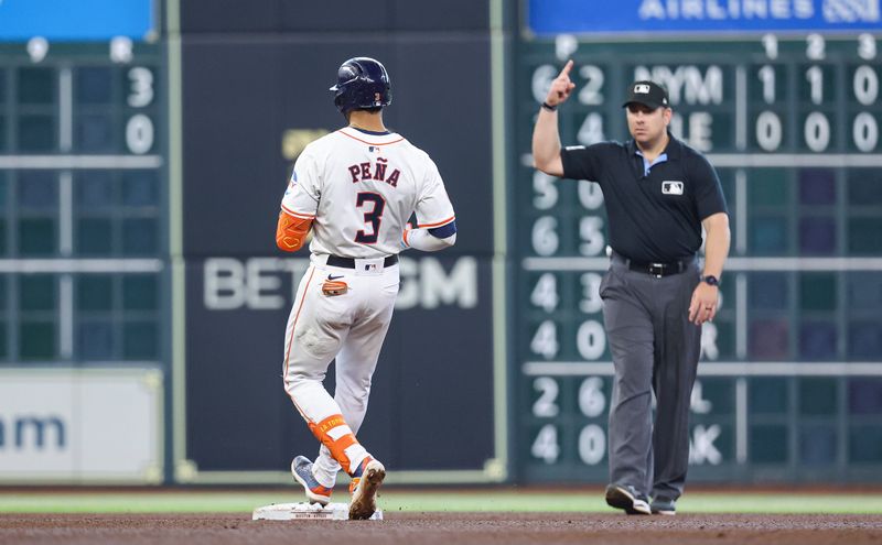 May 22, 2024; Houston, Texas, USA; Houston Astros shortstop Jeremy Pena (3) pulls into secon base as umpire John Libka signals a home run during the fourth inning against the Los Angeles Angels at Minute Maid Park. The home run call was overturned upon review and ruled a double. Mandatory Credit: Troy Taormina-USA TODAY Sports