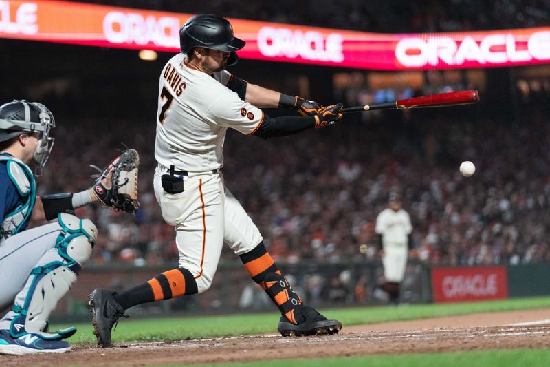 Jul 3, 2023; San Francisco, California, USA;  San Francisco Giants third baseman J.D. Davis (7) hits a double during the ninth inning against the Seattle Mariners at Oracle Park. Mandatory Credit: Stan Szeto-USA TODAY Sports