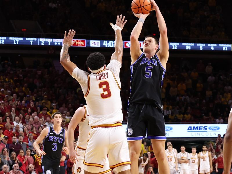 Mar 4, 2025; Ames, Iowa, USA; Brigham Young Cougars forward Mihailo Boskovic (5) shoots over Iowa State Cyclones guard Tamin Lipsey (3) during the second half at James H. Hilton Coliseum. Mandatory Credit: Reese Strickland-Imagn Images