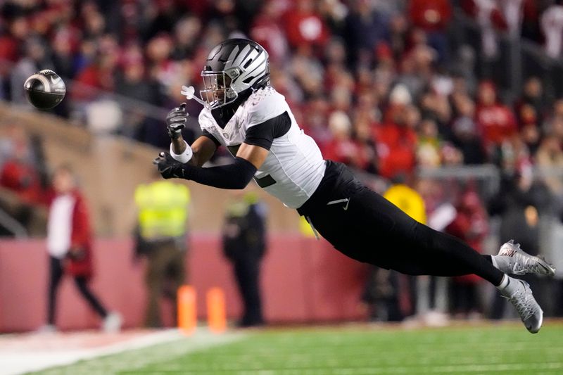 Nov 16, 2024; Madison, Wisconsin, USA;  Oregon Ducks wide receiver Gary Bryant Jr. (2) dives trying to catch a a pass during the second quarter against the Wisconsin Badgers at Camp Randall Stadium. Mandatory Credit: Jeff Hanisch-Imagn Images