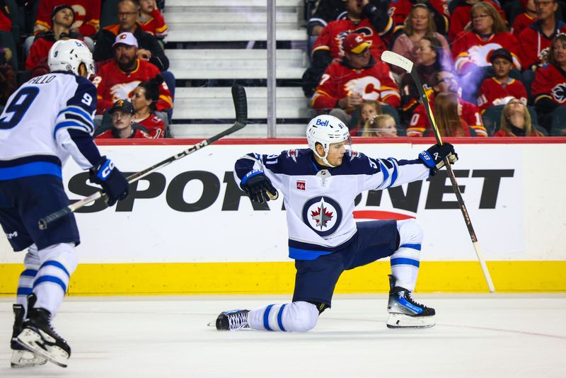 Oct 26, 2024; Calgary, Alberta, CAN; Winnipeg Jets center Cole Perfetti (91) celebrates his goal with teammates against the Calgary Flames during the third period at Scotiabank Saddledome. Mandatory Credit: Sergei Belski-Imagn Images