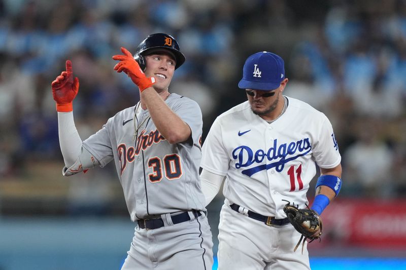 Sep 20, 2023; Los Angeles, California, USA; Detroit Tigers right fielder Kerry Carpenter (30) gestures after hitting a double in the eighth inning as Los Angeles Dodgers shortstop Miguel Rojas (11) watches  at Dodger Stadium. Mandatory Credit: Kirby Lee-USA TODAY Sports