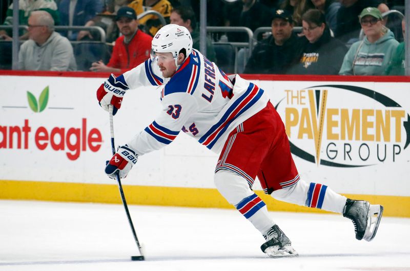 Mar 16, 2024; Pittsburgh, Pennsylvania, USA; New York Rangers left wing Alexis Lafreniere (13) passes the puck against the Pittsburgh Penguins during the first period at PPG Paints Arena. Mandatory Credit: Charles LeClaire-USA TODAY Sports