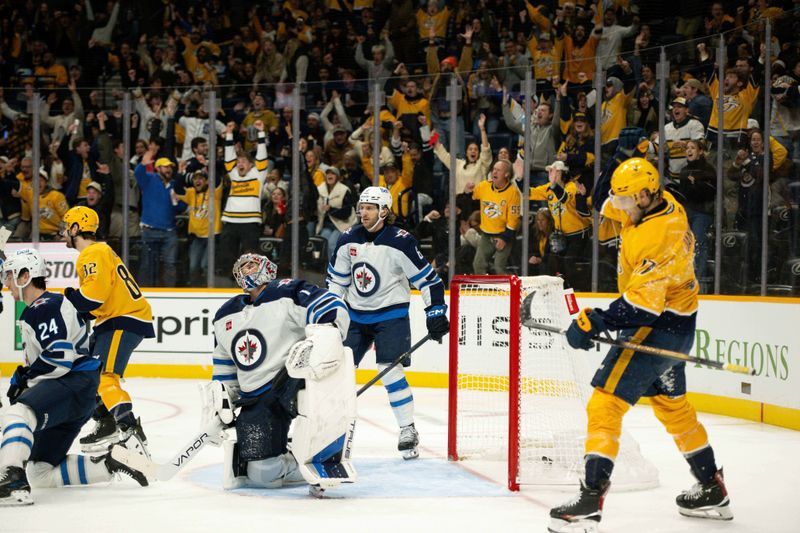 Nov 23, 2024; Nashville, Tennessee, USA;  Winnipeg Jets goaltender Eric Comrie (1) reacts after the goal from Nashville Predators center Tommy Novak (82) during the third period at Bridgestone Arena. Mandatory Credit: Steve Roberts-Imagn Images