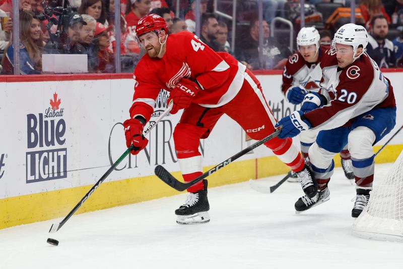 Feb 22, 2024; Detroit, Michigan, USA; Detroit Red Wings defenseman Jeff Petry (46) skates with the puck chased by Colorado Avalanche center Ross Colton (20) in the first period at Little Caesars Arena. Mandatory Credit: Rick Osentoski-USA TODAY Sports