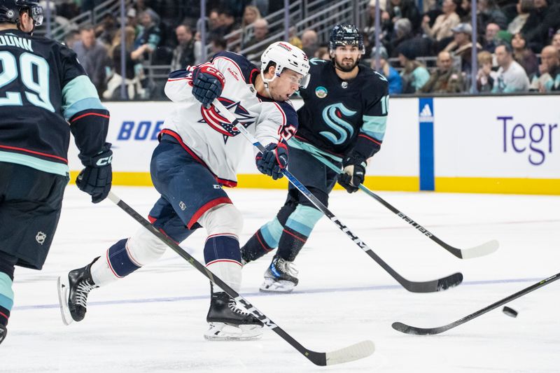 Jan 28, 2024; Seattle, Washington, USA; Columbus Blue Jackets forward Yegor Chinakhov (59) takes a shot during the third period against the Seattle Kraken at Climate Pledge Arena. Mandatory Credit: Stephen Brashear-USA TODAY Sports