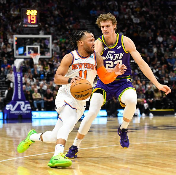 SALT LAKE CITY, UTAH - DECEMBER 13: Jalen Brunson #11 of the New York Knicks drives past Lauri Markkanen #23 of the Utah Jazz during the first half of a game at Delta Center on December 13, 2023 in Salt Lake City, Utah. NOTE TO USER: User expressly acknowledges and agrees that, by downloading and or using this photograph, User is consenting to the terms and conditions of the Getty Images License Agreement. (Photo by Alex Goodlett/Getty Images)