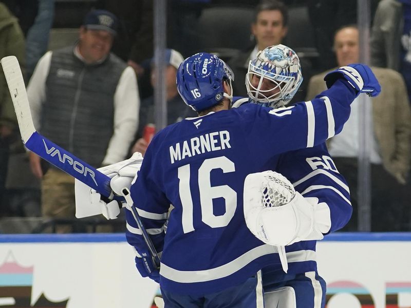 Nov 20, 2024; Toronto, Ontario, CAN; Toronto Maple Leafs forward Mitch Marner (16) congratulates goaltender Joseph Woll (60) on his shutout against the Vegas Golden Knights at Scotiabank Arena. Mandatory Credit: John E. Sokolowski-Imagn Images