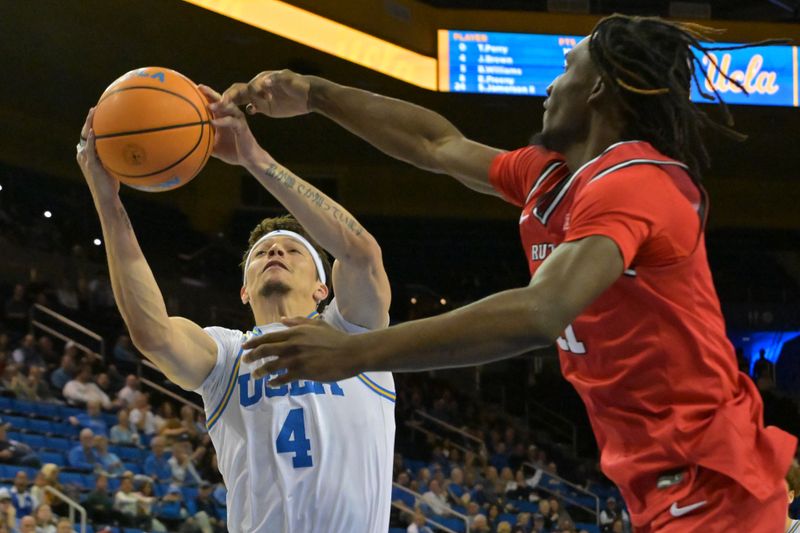 Feb 3, 2026; Los Angeles, California, USA; UCLA Bruins guard Jamar Brown (4) reaches in front of Rutgers Scarlet Knights forward Chris Nwuli (11) for a rebound in the second half at Pauley Pavilion presented by Wescom Financial. Mandatory Credit: Jayne Kamin-Oncea-Imagn Images