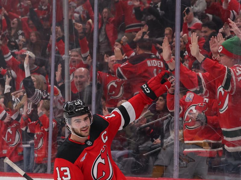 Jan 29, 2026; Newark, New Jersey, USA; New Jersey Devils center Nico Hischier (13) celebrates his overtime game winning goal against the Nashville Predators at Prudential Center. Mandatory Credit: Ed Mulholland-Imagn Images