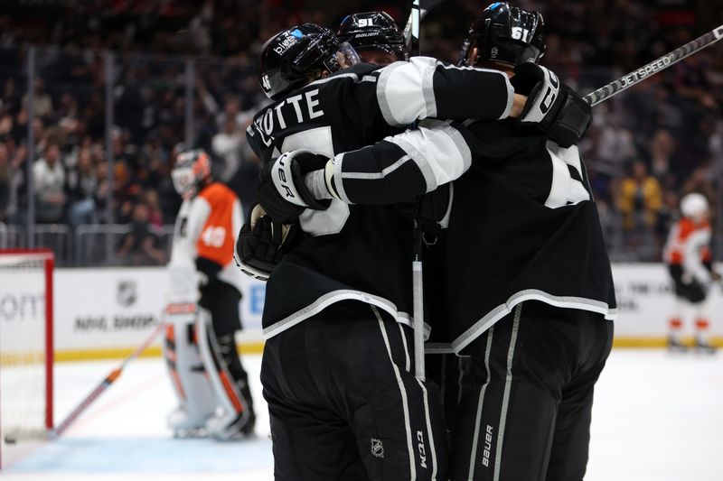 Nov 11, 2023; Los Angeles, California, USA;  Los Angeles Kings right wing Carl Grundstrom (91) celebrates with center Blake Lizotte (46) and center Trevor Lewis (61) after scoring a goal during the second period against the Philadelphia Flyers at Crypto.com Arena. Mandatory Credit: Kiyoshi Mio-USA TODAY Sports