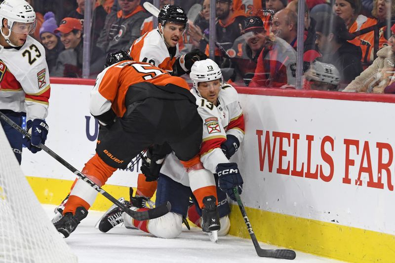 Dec 5, 2024; Philadelphia, Pennsylvania, USA; Florida Panthers center Sam Reinhart (13) battle for the puck with Philadelphia Flyers defenseman Rasmus Ristolainen (55) and center Morgan Frost (48) during the second period at Wells Fargo Center. Mandatory Credit: Eric Hartline-Imagn Images