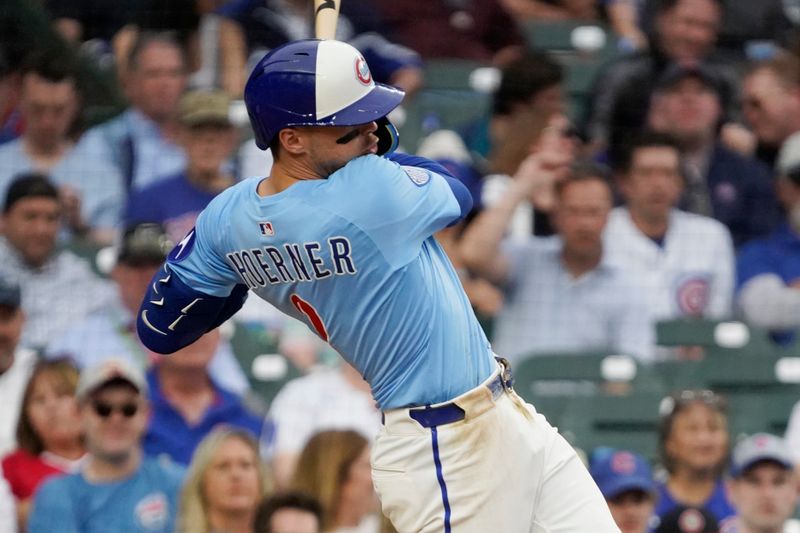 May 30, 2025; Chicago, Illinois, USA; Chicago Cubs second base Nico Hoerner (2) hits a double against the Cincinnati Reds during the eighth inning at Wrigley Field. Mandatory Credit: David Banks-Imagn Images