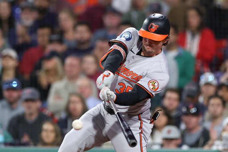 Sep 10, 2024; Boston, Massachusetts, USA; Baltimore Orioles designated hitter Adley Rutschman (35) hits a two run RBI single during the seventh inning against the Boston Red Sox at Fenway Park. Mandatory Credit: Paul Rutherford-Imagn Images