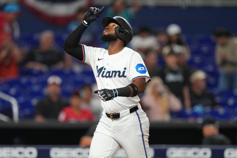 Apr 2, 2024; Miami, Florida, USA; Miami Marlins left fielder Bryan De La Cruz (14) looks to the sky after hitting a home run in the ninth inning against the Los Angeles Angels at loan Depot Park. Mandatory Credit: Jim Rassol-USA TODAY Sports