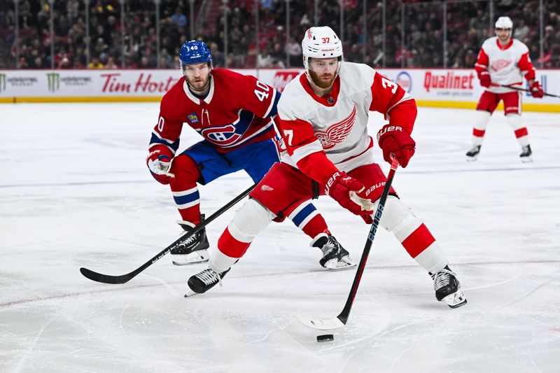 Dec 2, 2023; Montreal, Quebec, CAN; Detroit Red Wings left wing J.T. Compher (37) plays the puck against Montreal Canadiens right wing Joel Armia (40) during the second period at Bell Centre. Mandatory Credit: David Kirouac-USA TODAY Sports