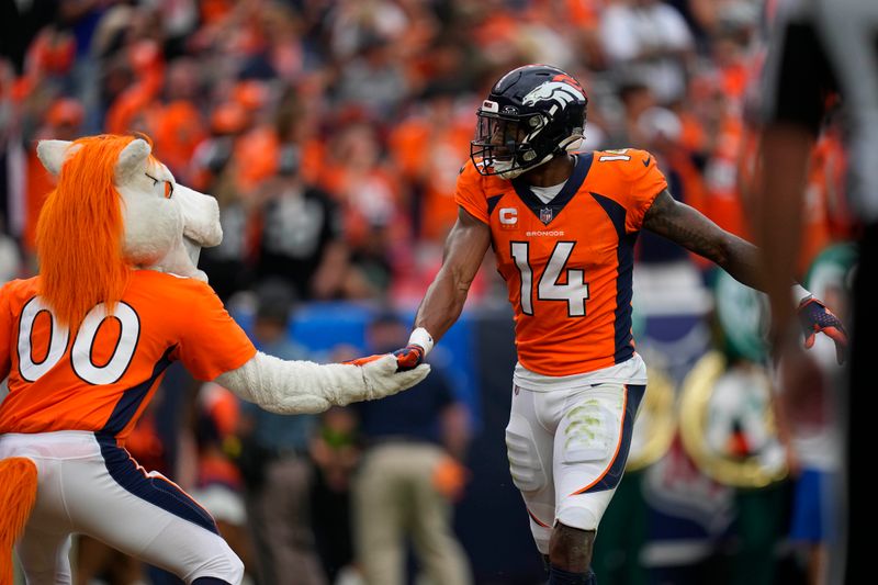 Denver Broncos wide receiver Courtland Sutton (14) celebrates a touchdown reception against the Las Vegas Raiders with Miles the Mascot during an NFL football game Sunday, Sept. 10, 2023, in Denver. (AP Photo/Jack Dempsey)