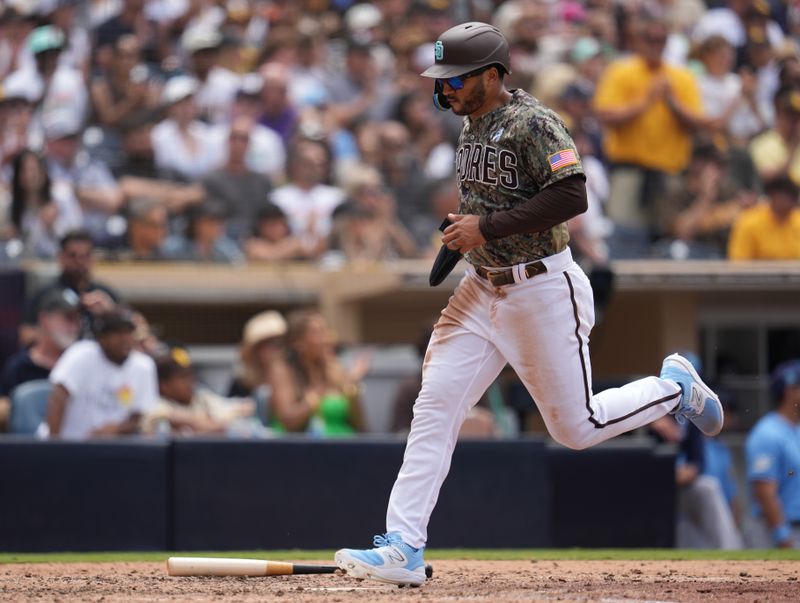 Jun 18, 2023; San Diego, California, USA;  San Diego Padres center fielder Trent Grisham (1) scores on an RBI single by third baseman Manny Machado (not pictured) during the fifth inning against the Tampa Bay Rays at Petco Park. Mandatory Credit: Ray Acevedo-USA TODAY Sports