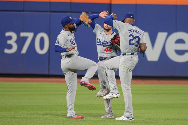 May 28, 2024; New York City, New York, USA; Los Angeles Dodgers left fielder Teoscar Hernandez (37) and center fielder Andy Pages (44) and right fielder Jason Heyward (23) reacts after defeating the New York Mets at Citi Field. Mandatory Credit: Vincent Carchietta-USA TODAY Sports