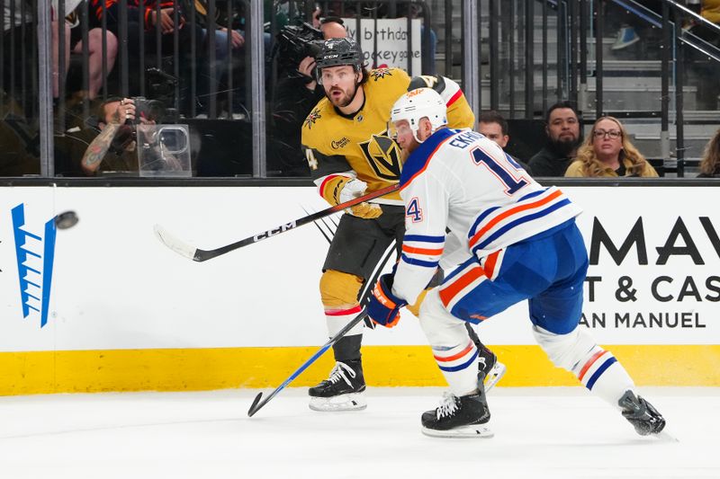 Mar 8, 2026; Las Vegas, Nevada, USA; Vegas Golden Knights defenseman Rasmus Andersson (4) shoots the puck behind Edmonton Oilers defenseman Mattias Ekholm (14) during the third period at T-Mobile Arena. Mandatory Credit: Stephen R. Sylvanie-Imagn Images