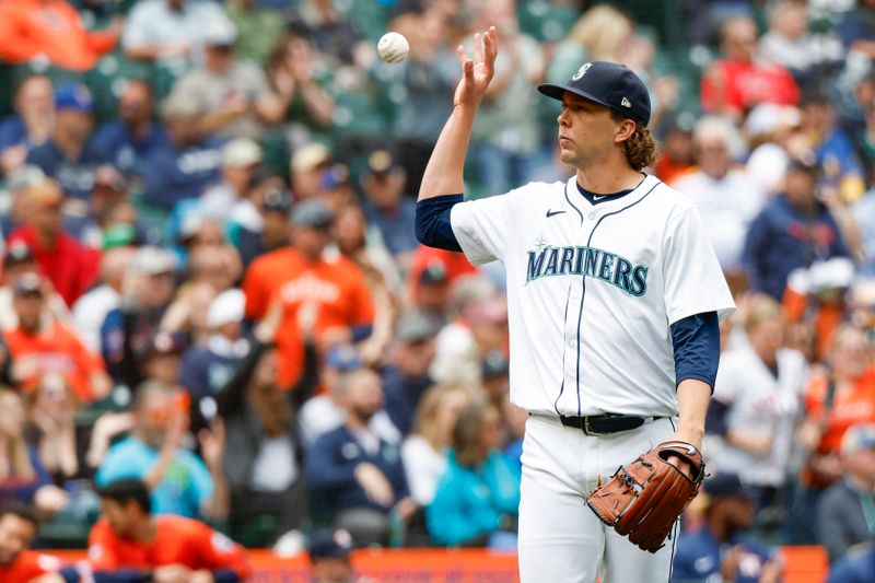 May 30, 2024; Seattle, Washington, USA; Seattle Mariners starting pitcher Logan Gilbert (36) receives a new baseball after surrendering a two-run home run against the Houston Astros during the fourth inning at T-Mobile Park. Mandatory Credit: Joe Nicholson-USA TODAY Sports