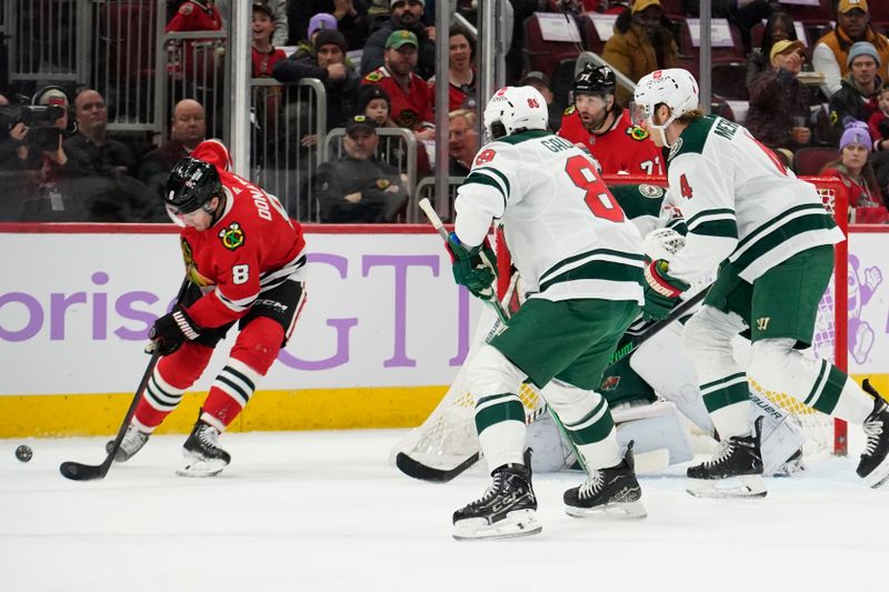 Jan 26, 2025; Chicago, Illinois, USA; Chicago Blackhawks center Ryan Donato (8) skate against the Minnesota Wild during the first period at United Center. Mandatory Credit: David Banks-Imagn Images