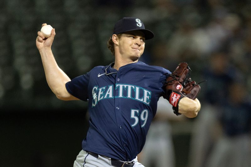 Sep 3, 2024; Oakland, California, USA; Seattle Mariners pitcher Troy Taylor (59) delivers a pitch against the Oakland Athletics during the eighth inning at Oakland-Alameda County Coliseum. Mandatory Credit: D. Ross Cameron-Imagn Images